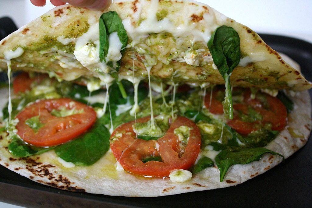 Inside of the pesto quesadilla as it's heating on a pan