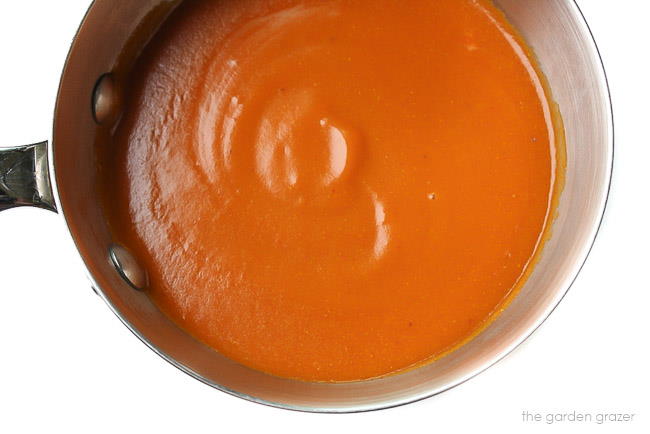 Warm homemade enchilada sauce in the pan