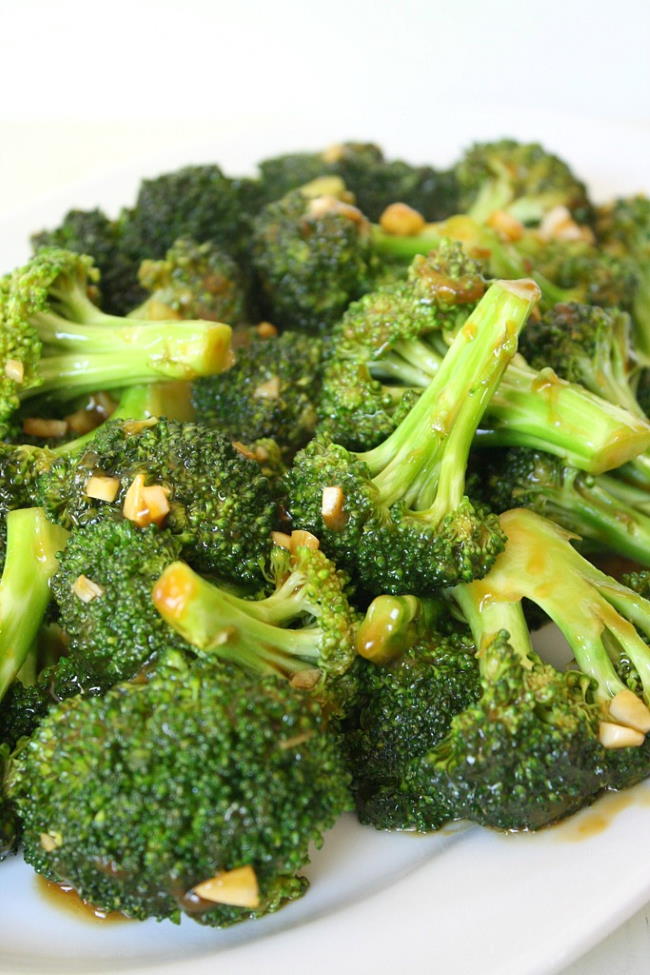 Cooked broccoli with garlic sauce on a plate