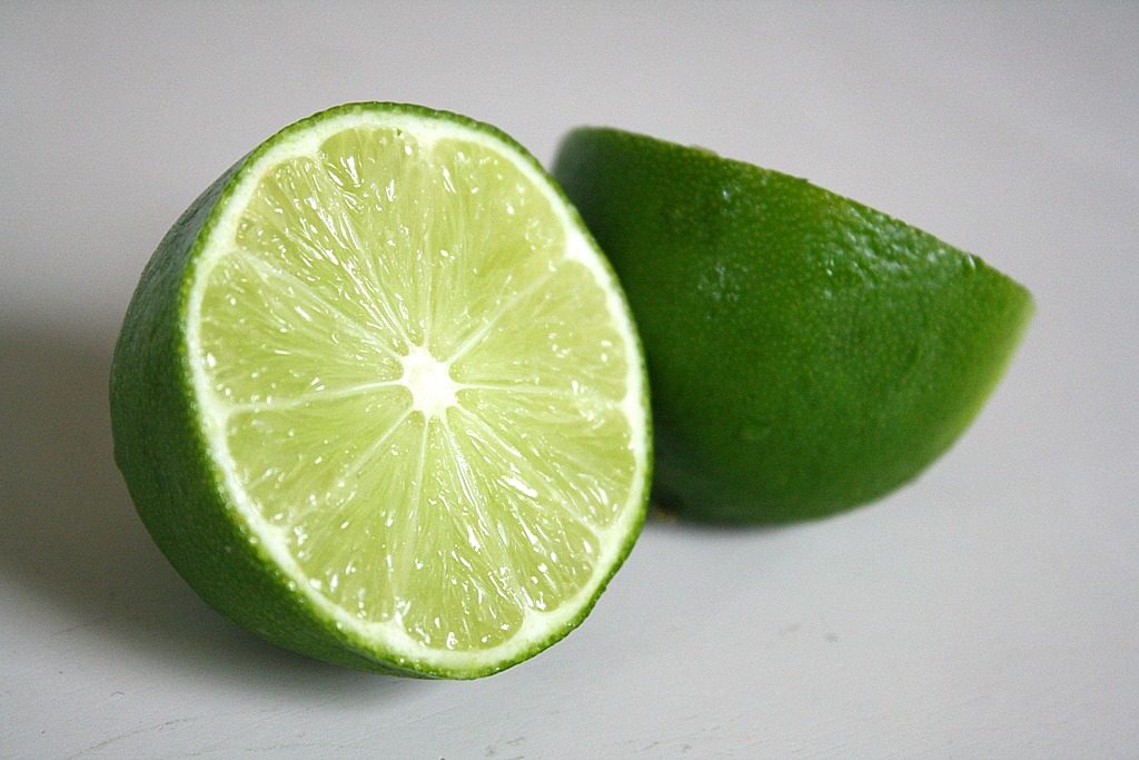 Lime cut in half on a cutting board