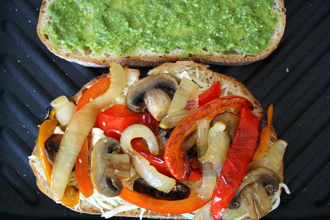 Vegan pesto panini cooking on a grill pan