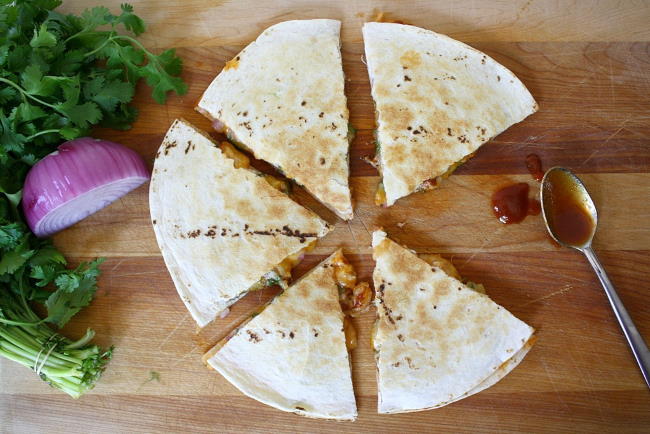 Vegan BBQ quesadilla cut into sections on a cutting board