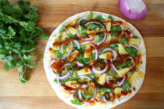Open-faced vegan Hawaiian-style quesadilla on a wooden cutting board