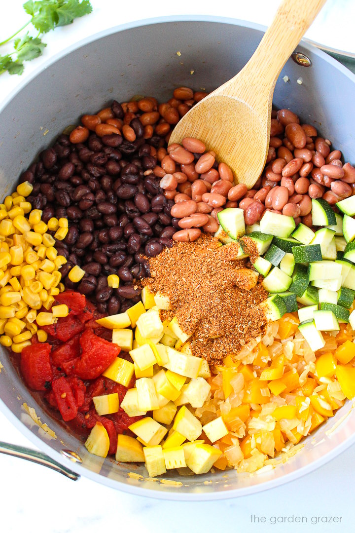 Overhead view of preparing chili ingredients in a large pot before mixing together