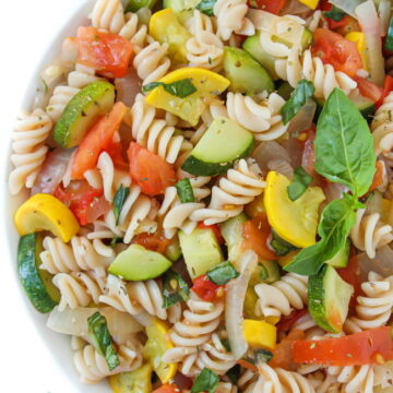 Bowl of fresh garden vegetable pasta with basil