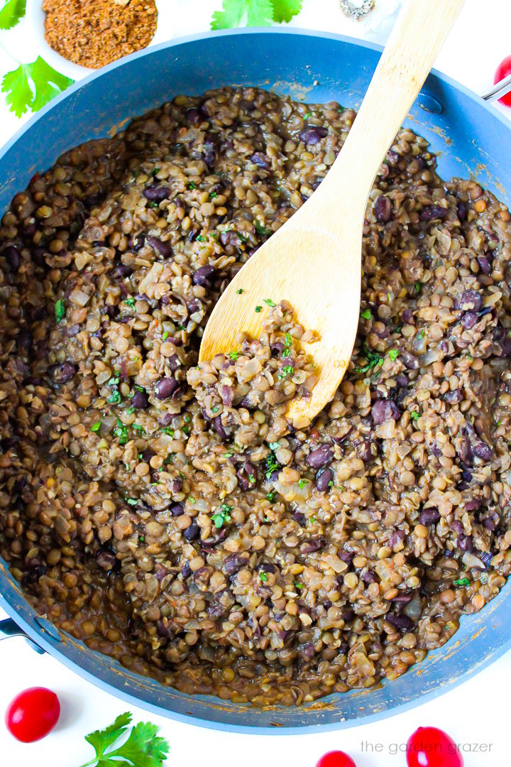 Overhead view of black bean lentil tacos mixture cooking in a large skillet