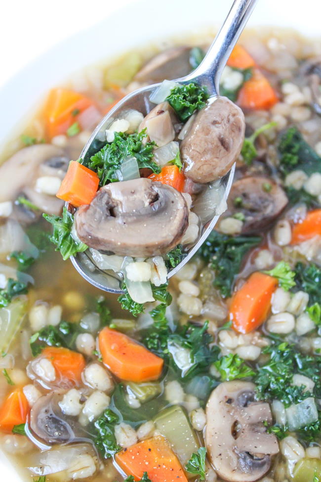 Close-up view of mushroom barley soup on a spoon