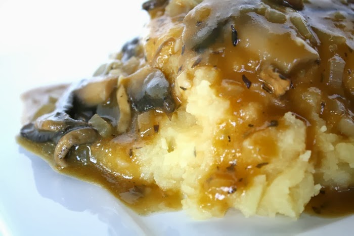 Vegan mushroom gravy poured over mashed potatoes