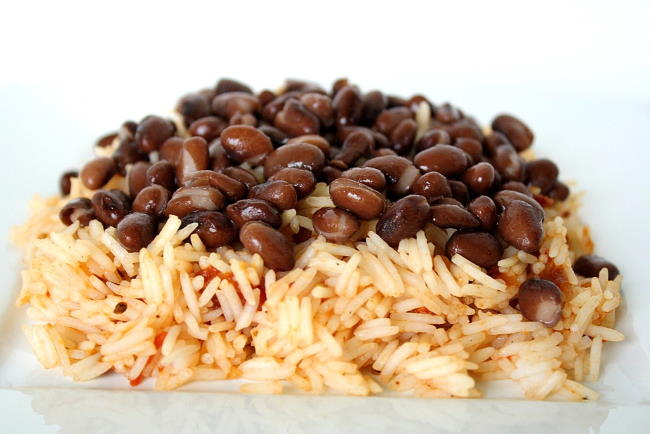 Brown rice topped with black beans on a plate