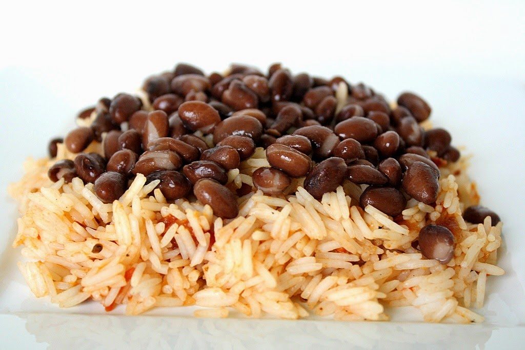 Brown rice topped with black beans on a plate