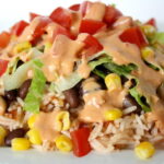 Black bean burrito bowl with creamy chipotle sauce on a plate