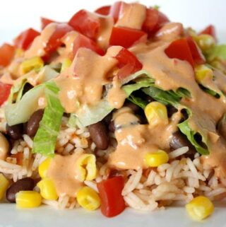 Black bean burrito bowl with creamy chipotle sauce on a plate