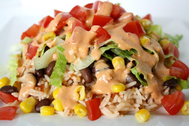 Black bean burrito bowl with creamy chipotle sauce on a plate