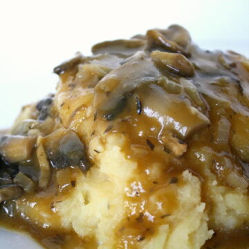 Plate of mashed potatoes with homemade gravy on top