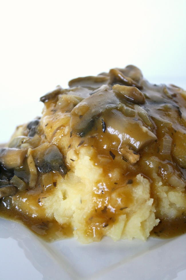 Plate of mashed potatoes with homemade gravy on top