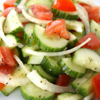 Cucumber salad with onions and tomato on a plate