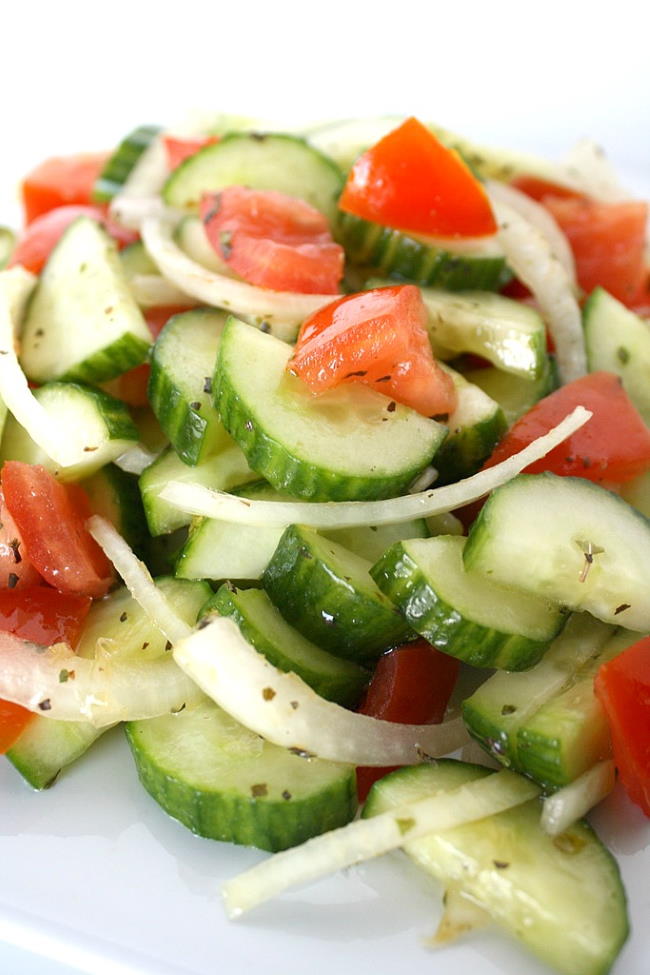 Cucumber salad with onions and tomato on a plate