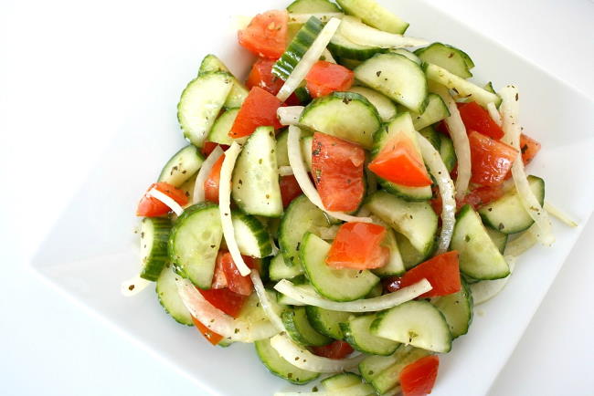 overhead view of cucumber tomato salad on a plate