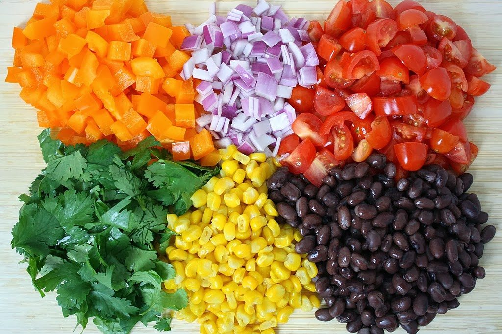 Ingredients on a cutting board for black bean citrus salad