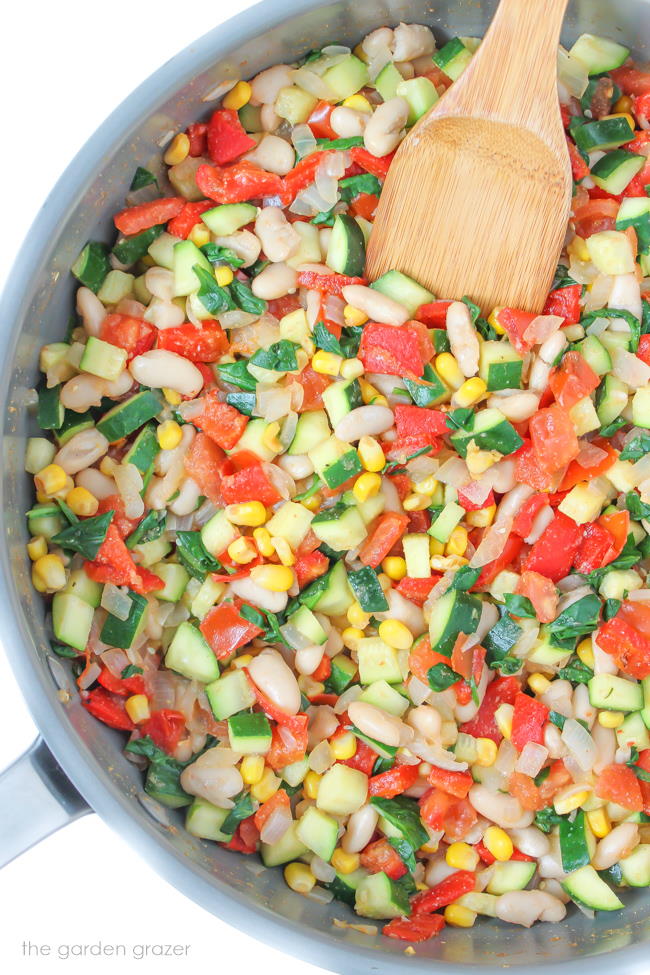 Filling for fresh enchiladas cooking in a pan with wooden spatula