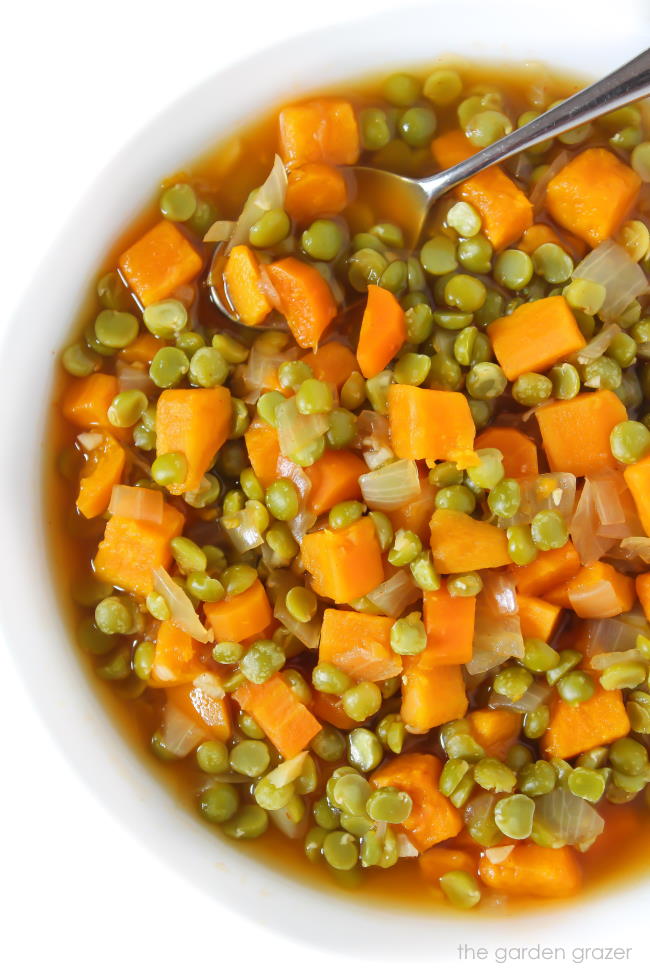 Vegan split pea soup with sweet potato in a white bowl