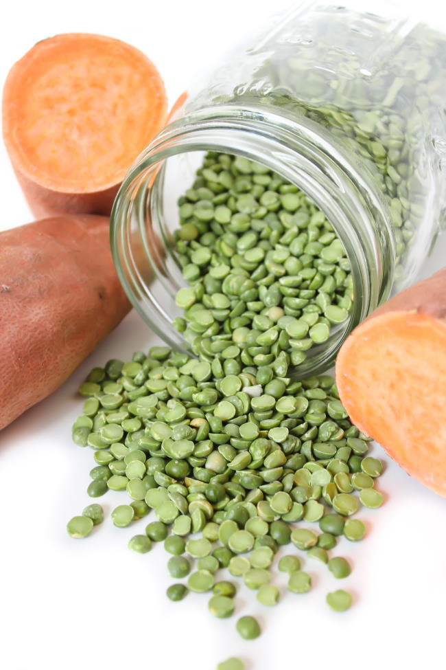 Jar of green split peas and sweet potatoes cut in half