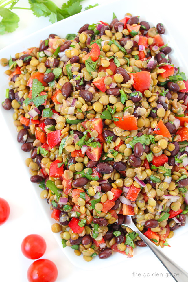 Protein-packed salad on a white plate with spoon