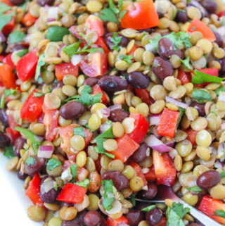 plate of vegan black bean lentil salad with tomato and cilantro