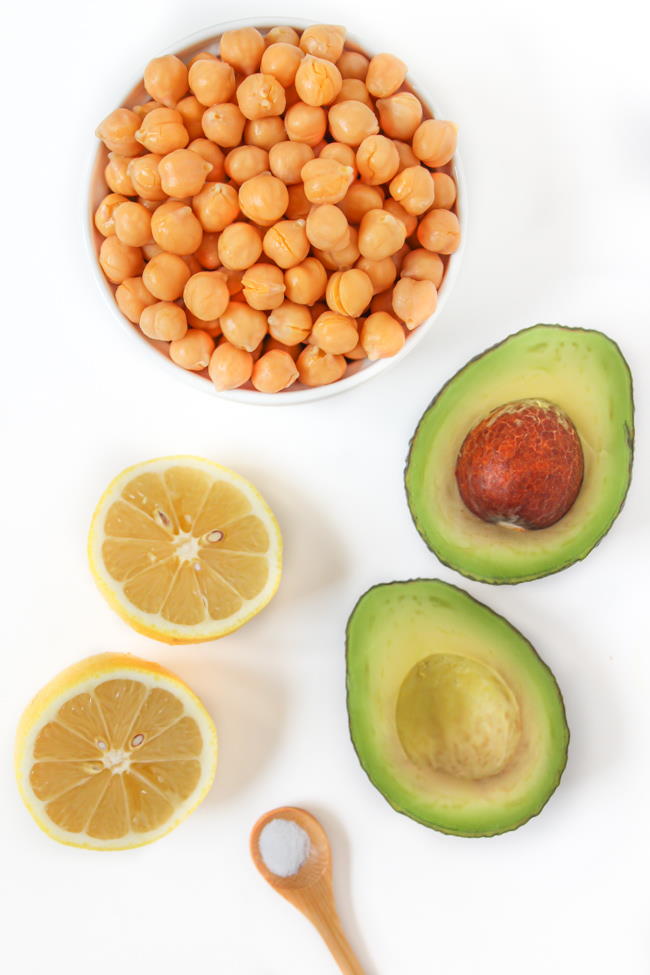 Ingredients laid out on a white table for chickpea avocado mash