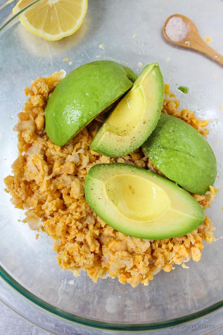 Overhead view of preparing ingredients in a large glass bowl before mixing together