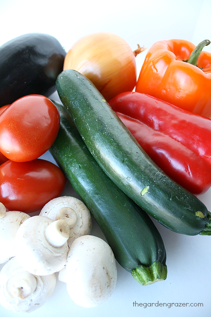 Assorted raw vegetables on a cutting board before roasting