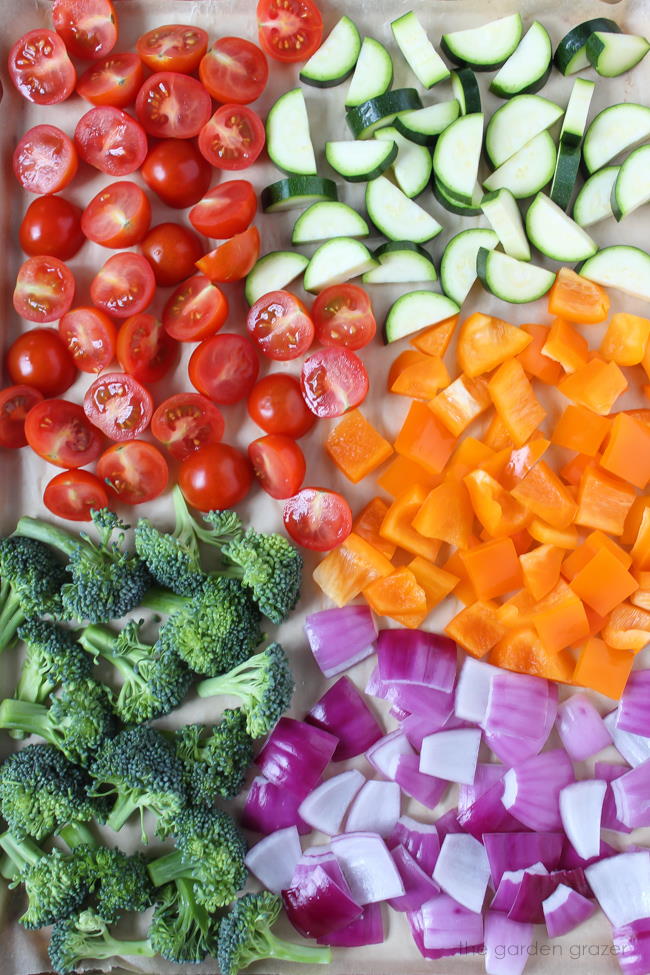 Sheet pan of chopped vegetables ready to be roasted