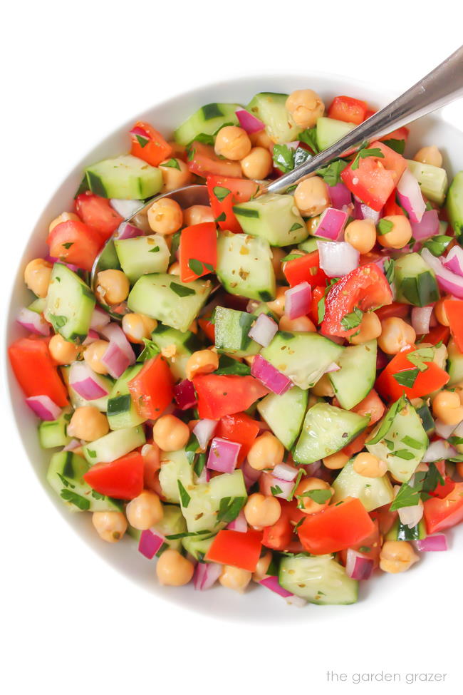 Greek Chopped Salad in a bowl with spoon