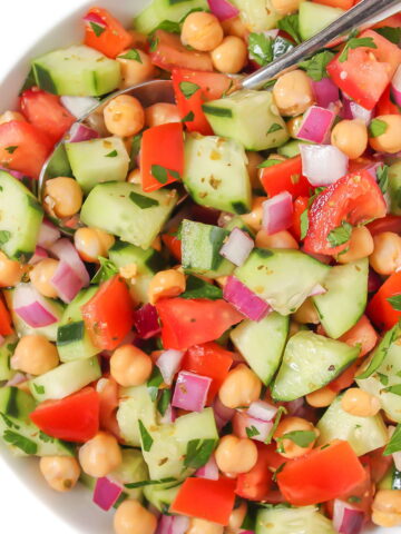 Greek chickpea chopped salad in a white bowl