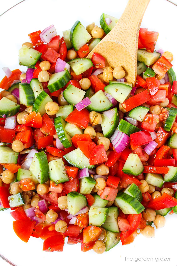 Overhead view of Greek Chopped Salad mixed together in a large glass bowl