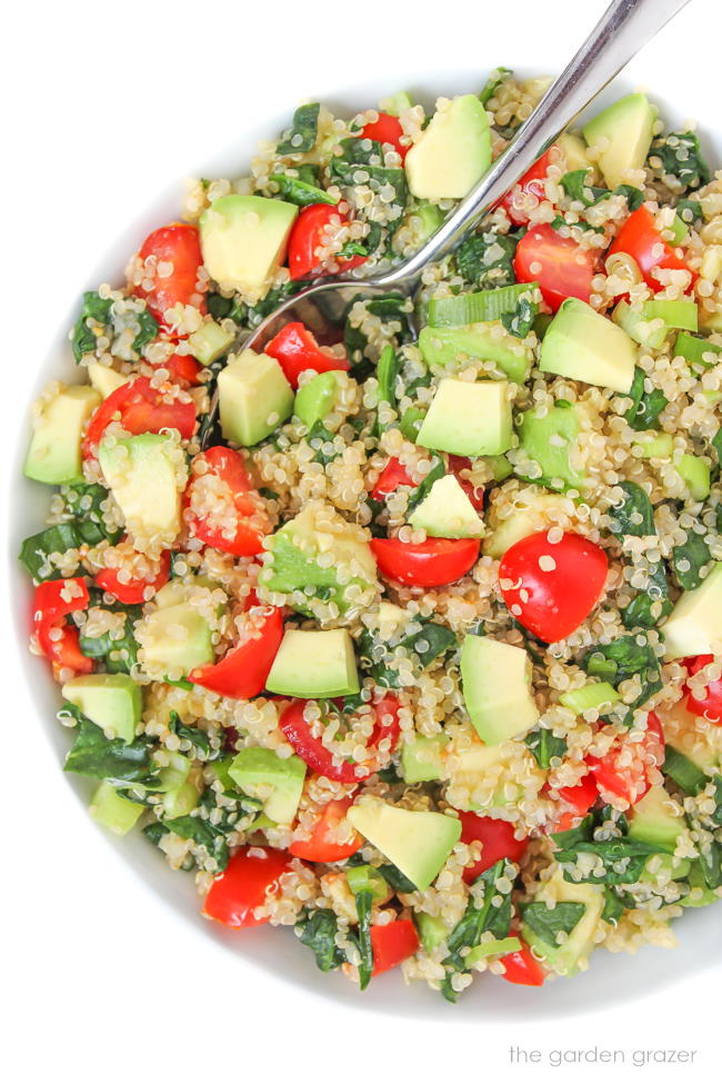 Power Salad with tomatoes in a bowl with spoon