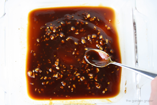 Marinade sauce mixed together in pan with a spoon