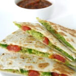 Avocado Quesadillas on a plate with bowl of salsa