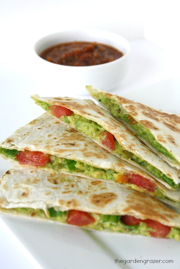 Avocado Quesadillas on a plate with bowl of salsa