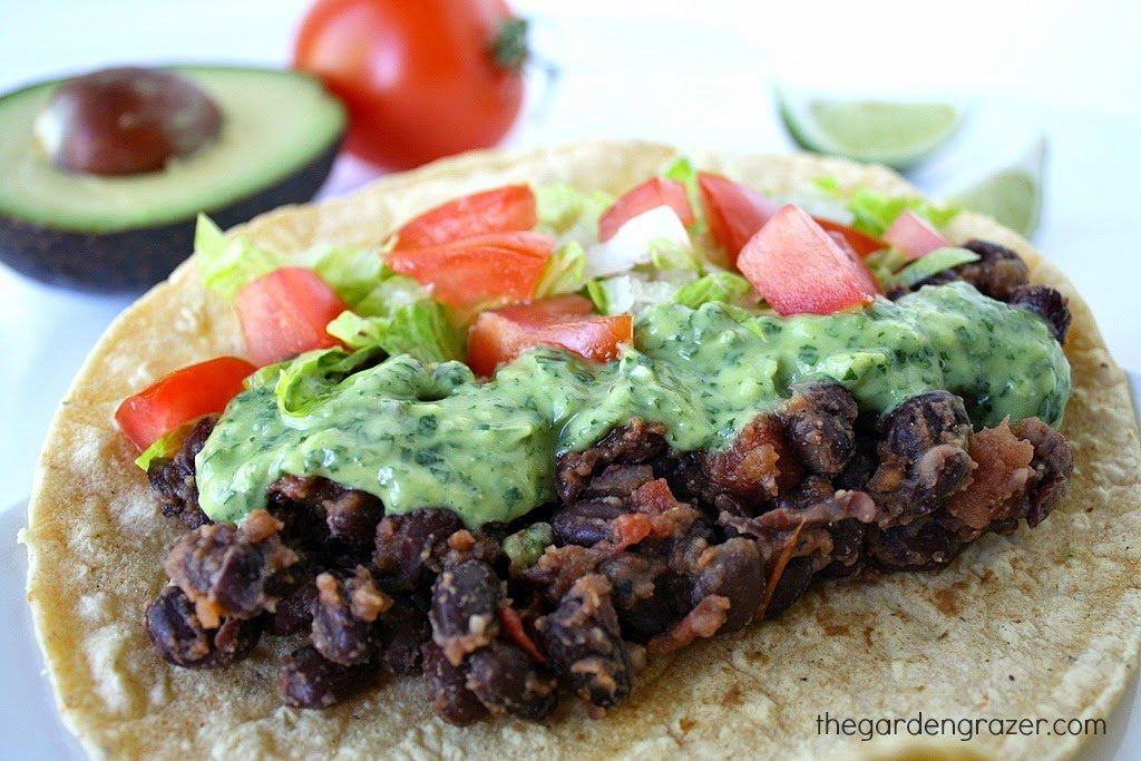 Black bean taco topped with avocado sauce
