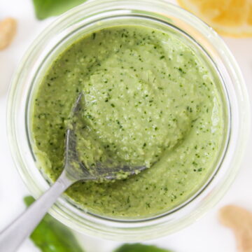 Small glass jar of vegan pesto with cashews, basil, and lemon