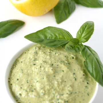 Small white bowl of vegan pesto with cashews, basil, and lemon