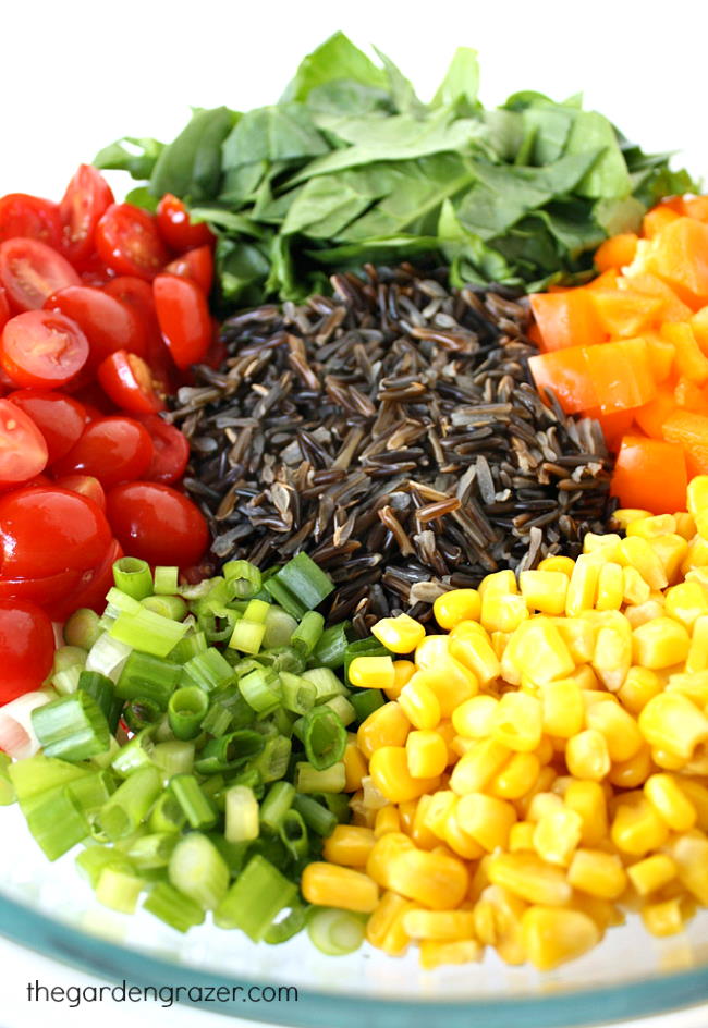 Spinach, sweet corn, tomato, bell pepper ingredients in a large bowl