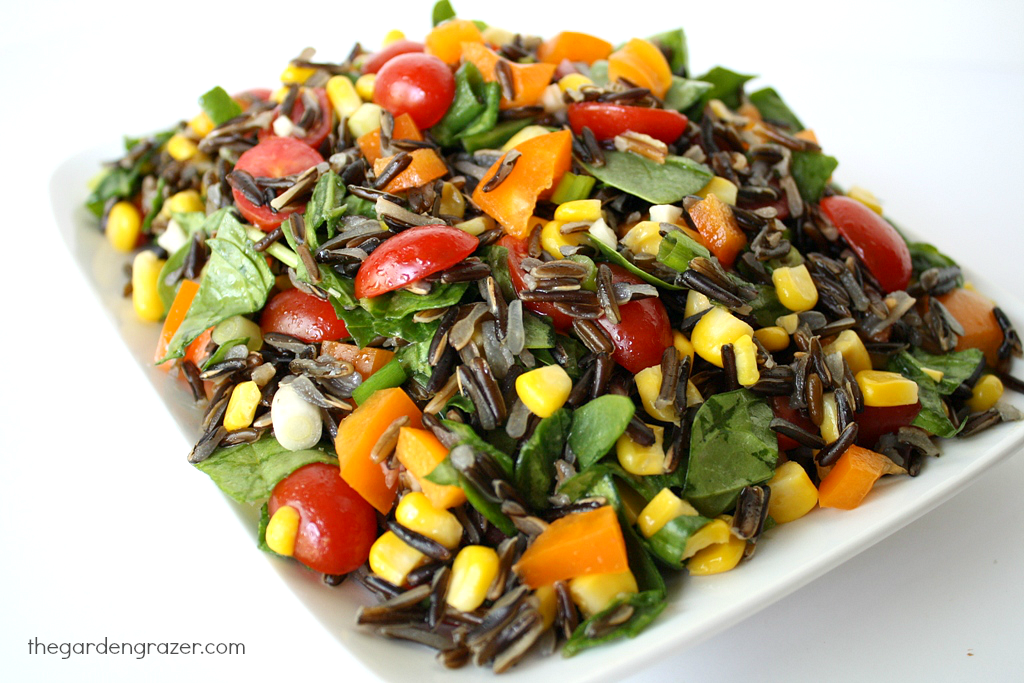 Plate of wild rice spinach salad with tomatoes