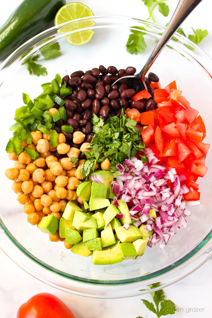 Overhead view of ingredients in a large glass bowl before mixing together