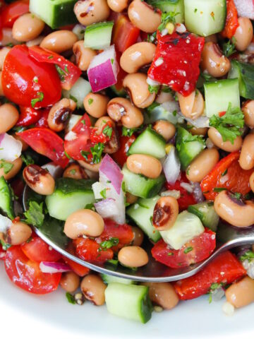 Close up view of black eyed pea salad with fresh veggies and herbs