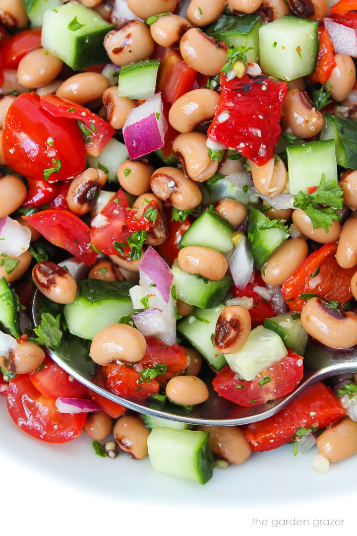 Close up view of black eyed pea salad with fresh veggies and herbs