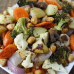 Roasted vegetables with chickpeas on a white plate