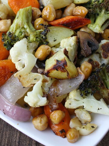 Roasted vegetables and chickpeas on a white plate