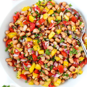Vegan oil-free black-eyed pea salad in a white bowl with spoon